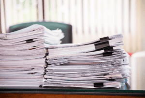 Stacks of legal documents representing case evidence in criminal trials under Michael Morton Act Texas