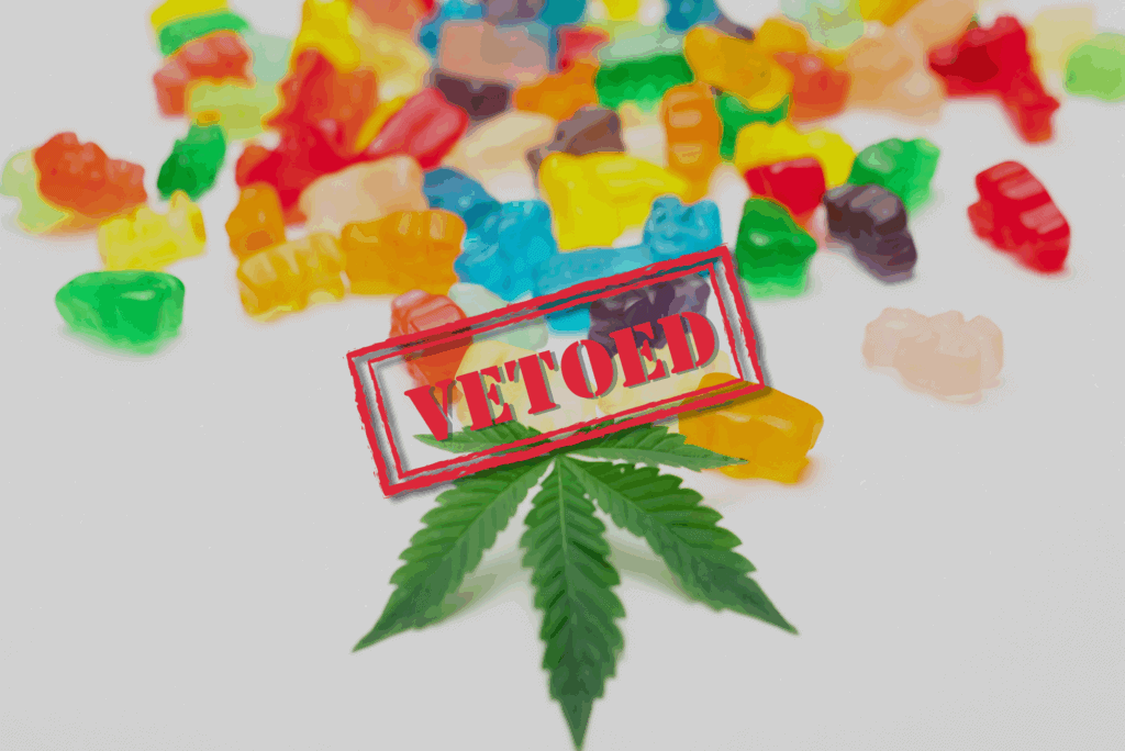 Assorted colorful THC-infused gummies on a white surface with a marijuana leaf, overlaid with the word "VETOED", referencing the governor’s rejection of a hemp THC product ban.